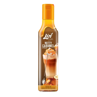 Bottle of Jin Nutty Caramel syrup with a glass of caramel syrup on a white background
