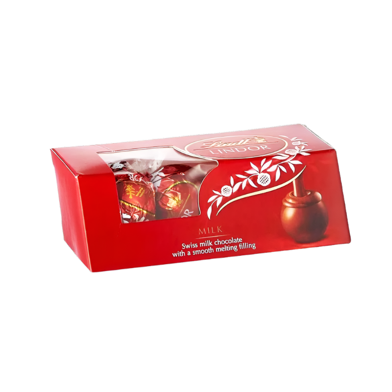 A box of Lindt Lindor Milk chocolate with a smooth melting experience, indicated by the tagline 'Smooth melting in your mouth'. The packaging is predominantly red with an image of the chocolate pieces and a milk chocolate tree.