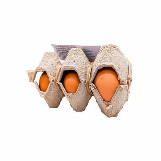 Three brown cardboard egg cartons holding bright orange eggs, arranged side by side on a plain white background.