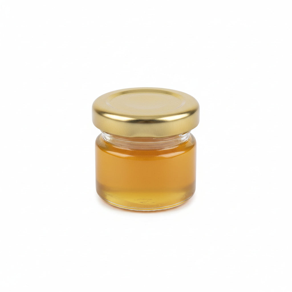 Small jar of honey on a wooden surface