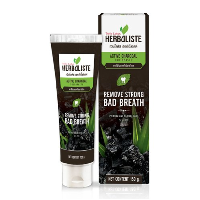 Packaging of Twin Lotus Active Charcoal Toothpaste Herbaliste Triple Action. The box and tube are primarily black and green with images of charcoal and herbs, text detailing product benefits, and a weight indication of 150g.