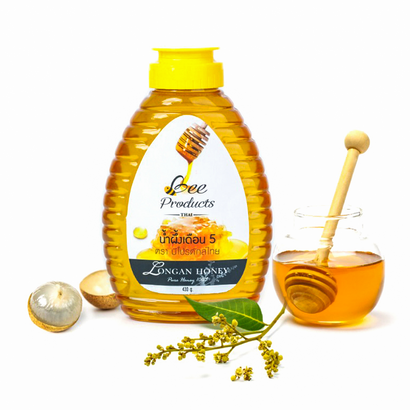 A jar of Bee Products Thai Longan Honey 430g with a yellow cap, accompanied by a glass of honey and dried longan fruit.